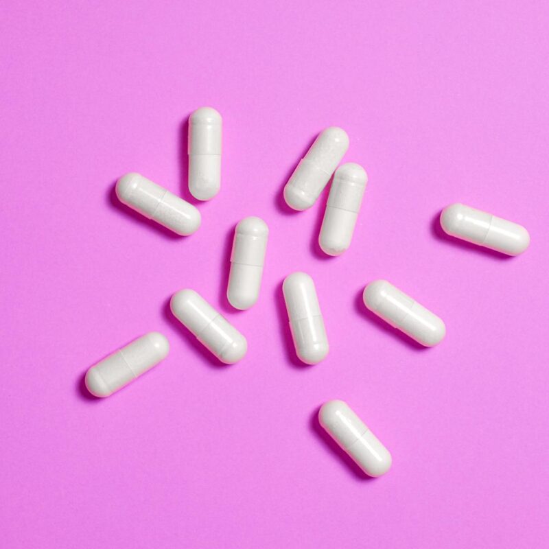 white medicine capsule in close up photography
